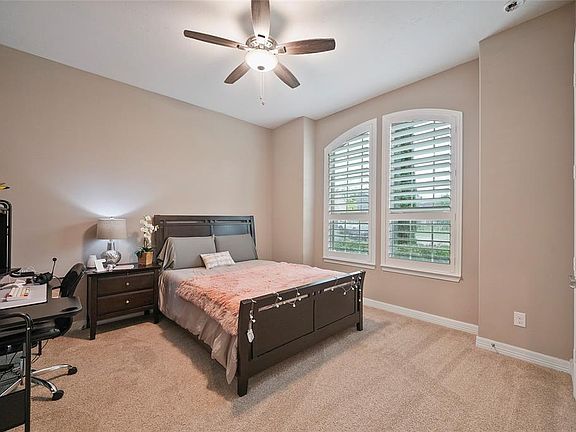 The first of the secondary bedrooms has plantation shutters on the cute arched window, lots of space and a great size closet. This bedroom has a Jack and Jill bathroom.