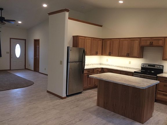 Front door with living room and large open kitchen.