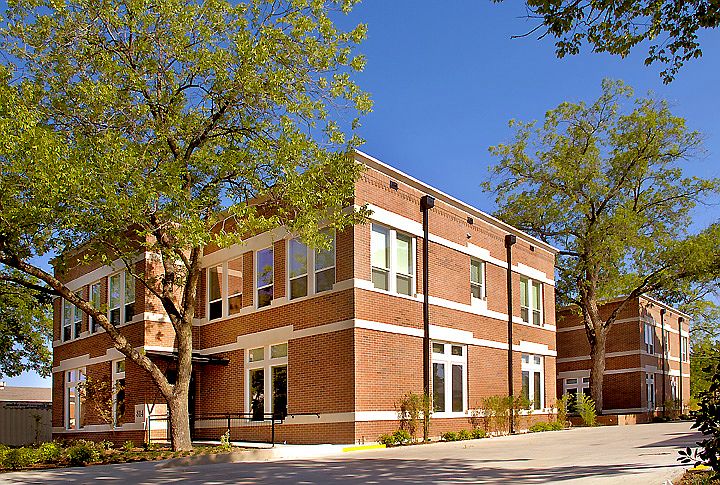Full image of building, entrance to apartments is along back.