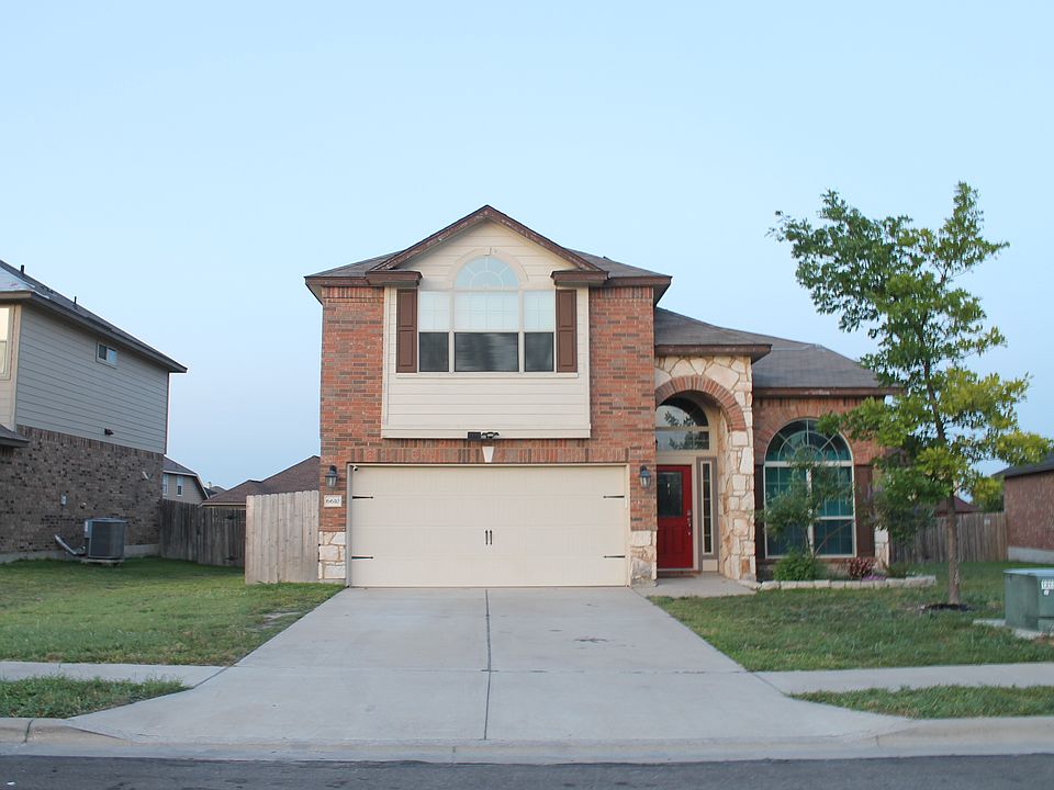 Two car garage, beautiful arched windows providing lots of natural light to front family room and main suite above garage.