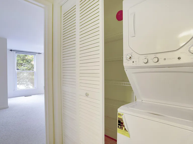 Washer dryer and hallway closet at the top of the stairs to the 2nd floor. entry to master bedroom.