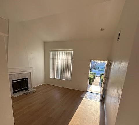 Living room and fireplace, vaulted ceiling. New hardwood floors through out the house.