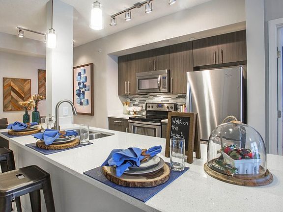 Kitchen and kitchen island within open concept apartment in Boca Raton.
