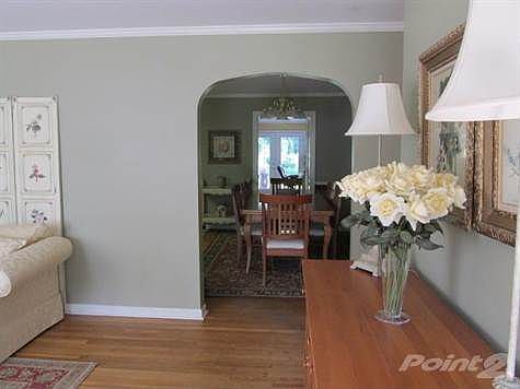 Looking from the front door through the living room and dining room to the doors from the family room.