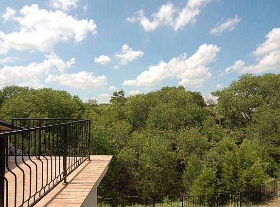 Balcony overlooking the treed area.