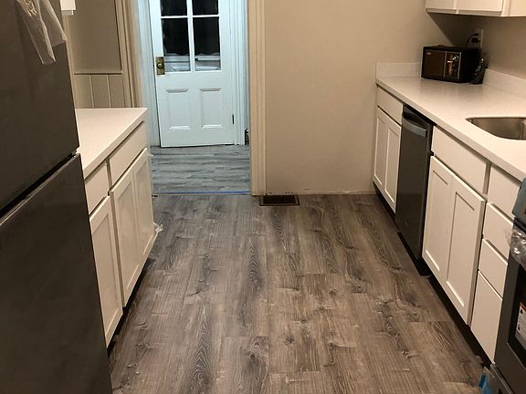 Kitchen view towards rear entrance.