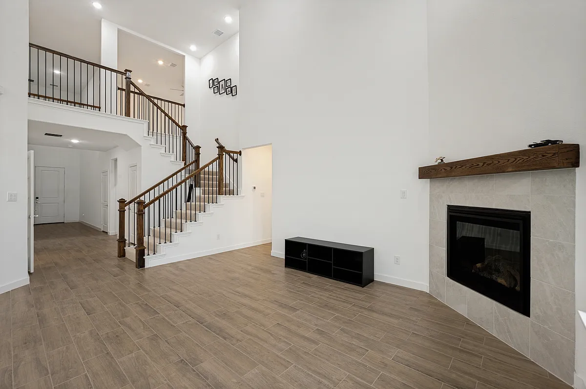 living room features soaring double-height ceilings and a floor-to-ceiling gas fireplace - 108 Invermore Dr