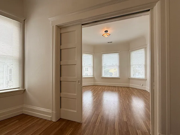 looking from inner living room through pocket doors to front living room