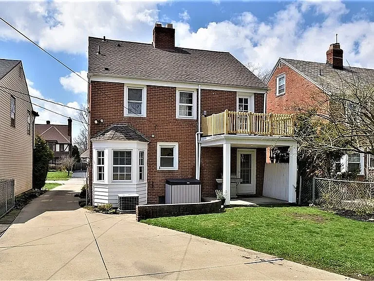 Back of the house looking at the 2nd story patio/deck and lower patio