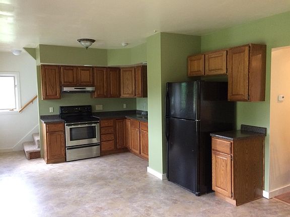 Inquire at www.RentAugustaMaine.com Kitchen. Stairs lead up to two bedrooms and a full bath
