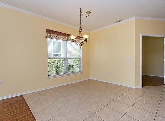 French doors lead to the office and new fixture in place in dining area.