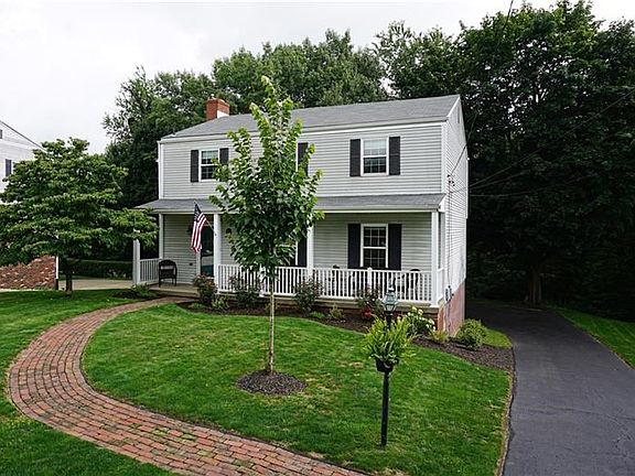 Striking curb appeal includes professional landscaping and a private tree lined home site.