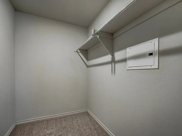 Explore the potential of this spacious walk-in closet, perfect for organizing your wardrobe.