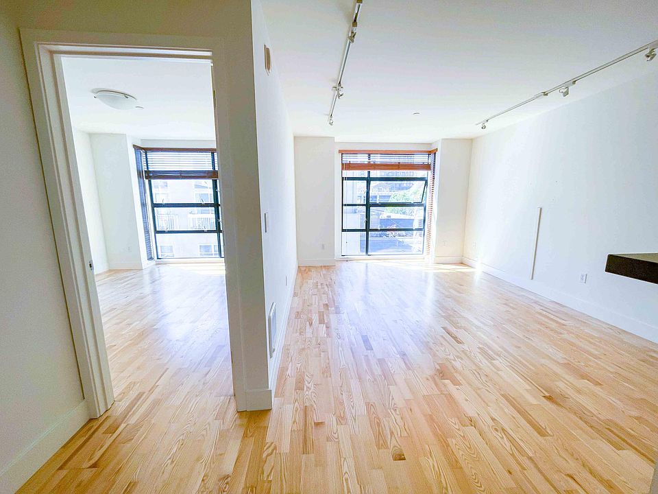 Master bedroom and living room. Floor to ceiling windows allow tons of natural light in the unit.