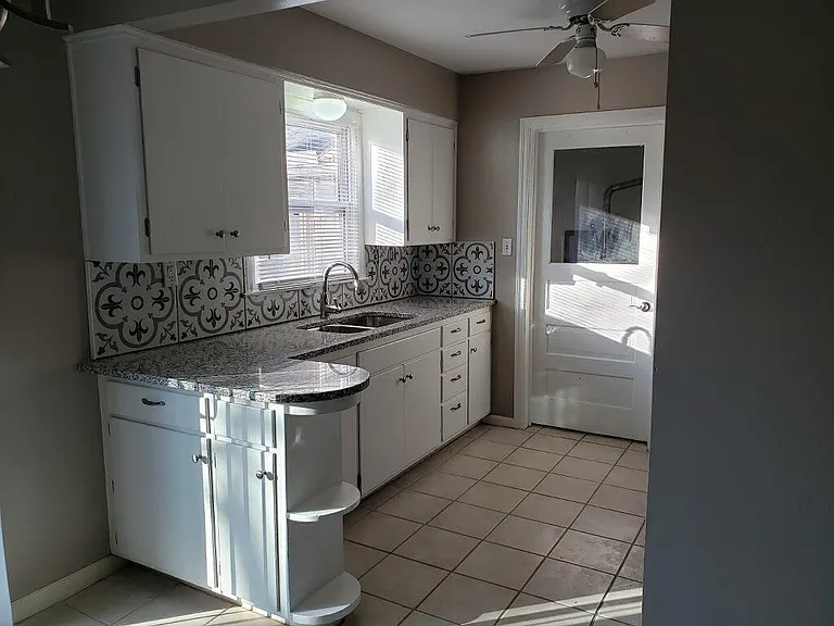 Kitchen has loads of storage, new backsplash, granite, newly painted cabinets, tiled floor. Charming!