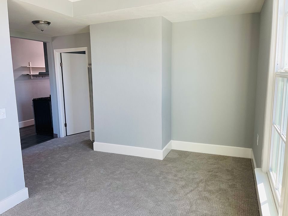 Living Room with Desk Nook, the kitchen is to the far left and the door to the bedroom is on the right.