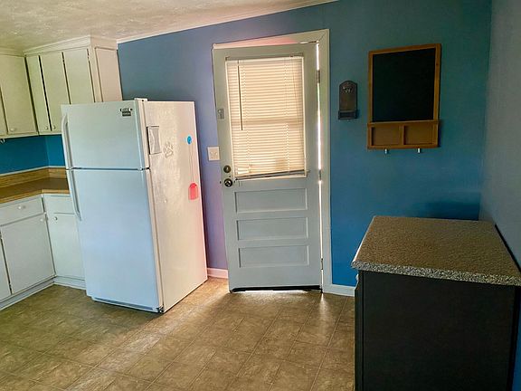 Eat in Kitchen has stove, refrigerator and dishwasher. OFF carport.