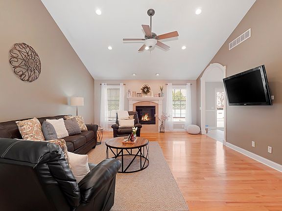 Volume ceilings, solid hardwood floors, recessed lighting and gas fireplace!