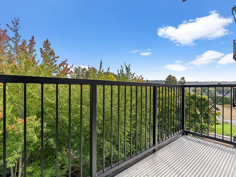 Relax on your private balcony with peaceful tree-lined views. Relax on your private balcony with peaceful tree-lined views.