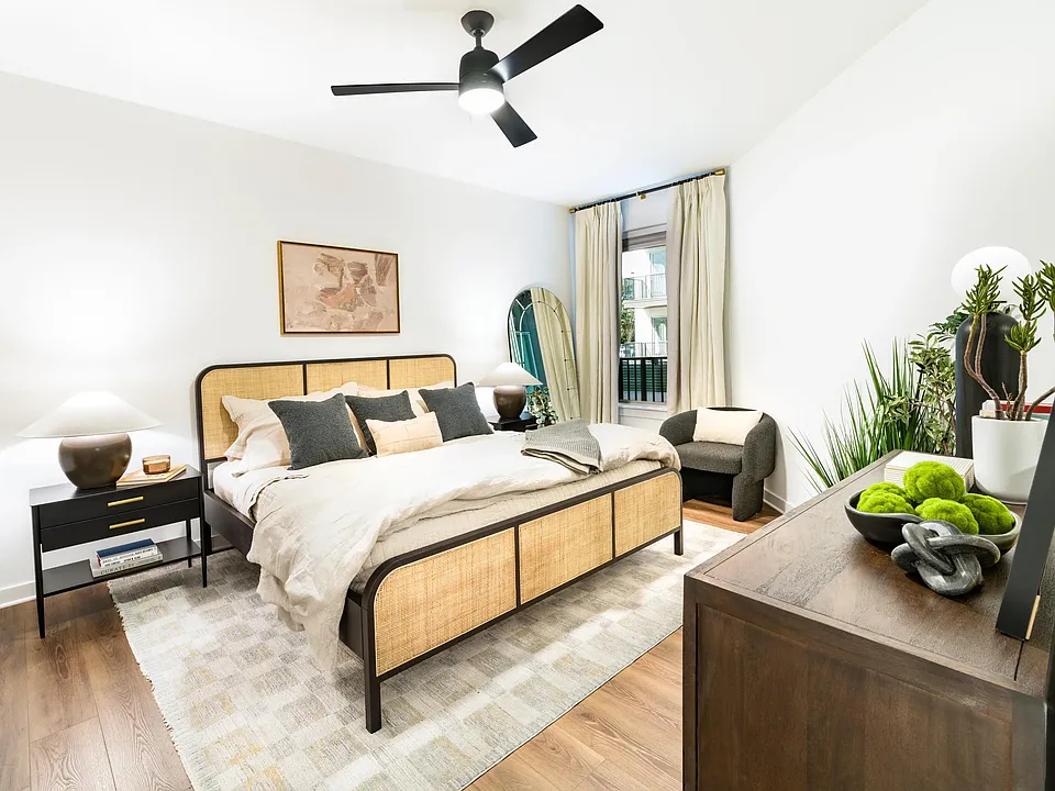 A spacious bedroom at Modera Nations in Nashville features wide-plank flooring, abundant natural light, and a clean, versatile layout for everyday living.