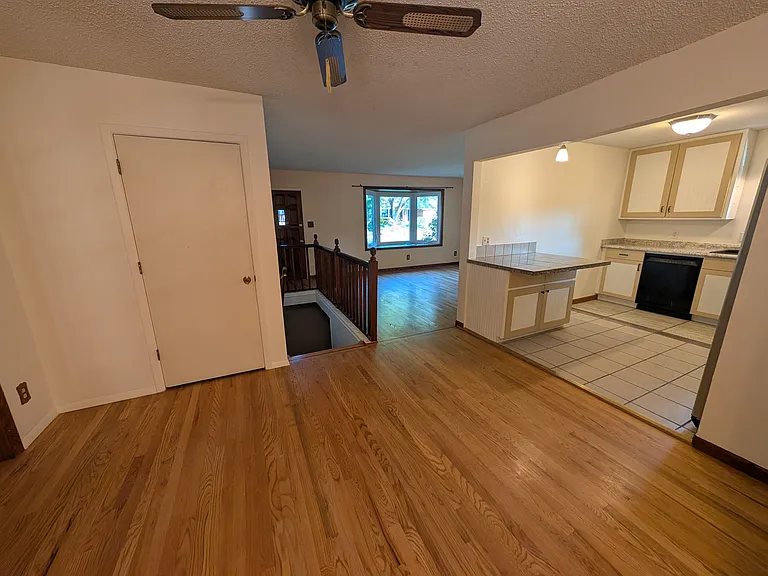dinning room with view to living room and kitchen. (behind the closed door is a spacious pantry)
