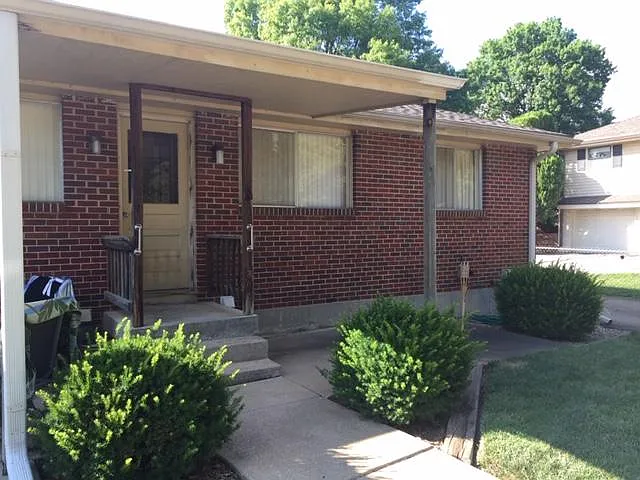 Unit 1 back entrance with patio.