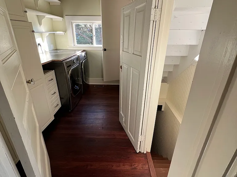 Laundry room is accessed through the kitchen. From there go up to the office or down to the second bedroom and basement.