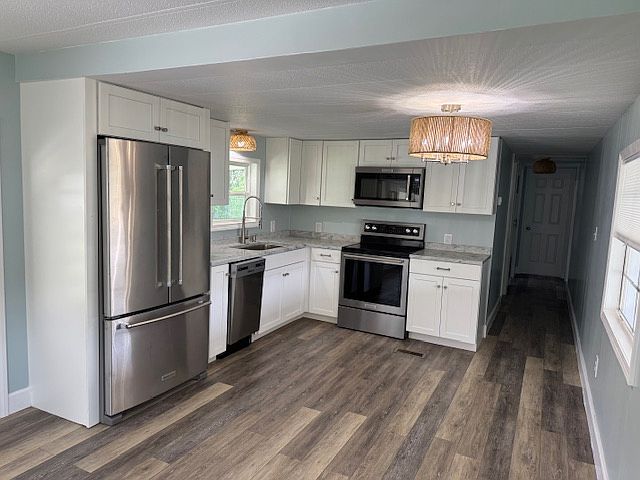 Kitchen has all new Kitchen Aid stainless steel appliances and Whirlpool dishwasher. Granite countertop and all new cabinets.