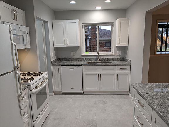 New Kitchen - shaker cabinents, dishwasher, large-deep sink, gas stove, fridge, microwave, new flooring. Lots of storage and brightly lit