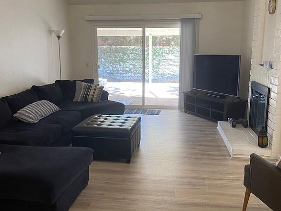 Living room, gas log fireplace and slider to covered patio and fenced back yard.