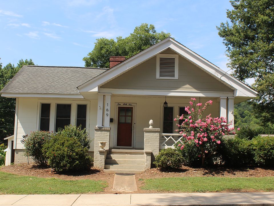Front of house with porch and swing.