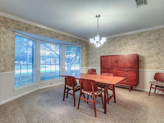 The bay window allows ample natural light into the dining room. New carpet in 2017.