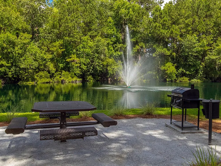 Our inviting picnic table and charcoal grill beside the lake create the perfect setting for outdoor gatherings.