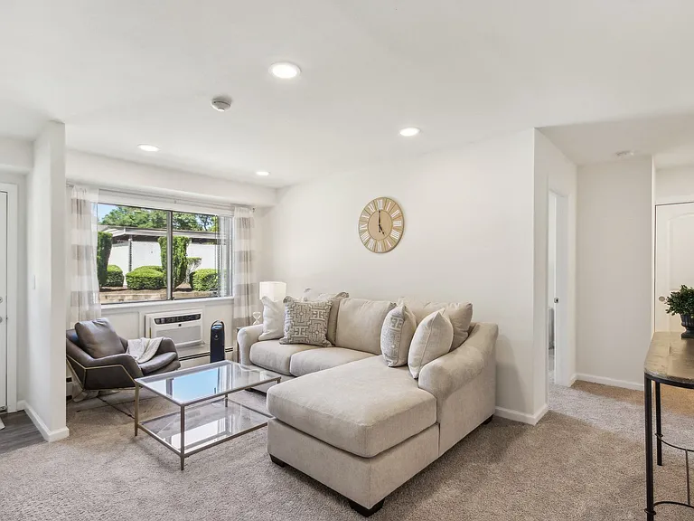 a spacious living room with a couch and a coffee table