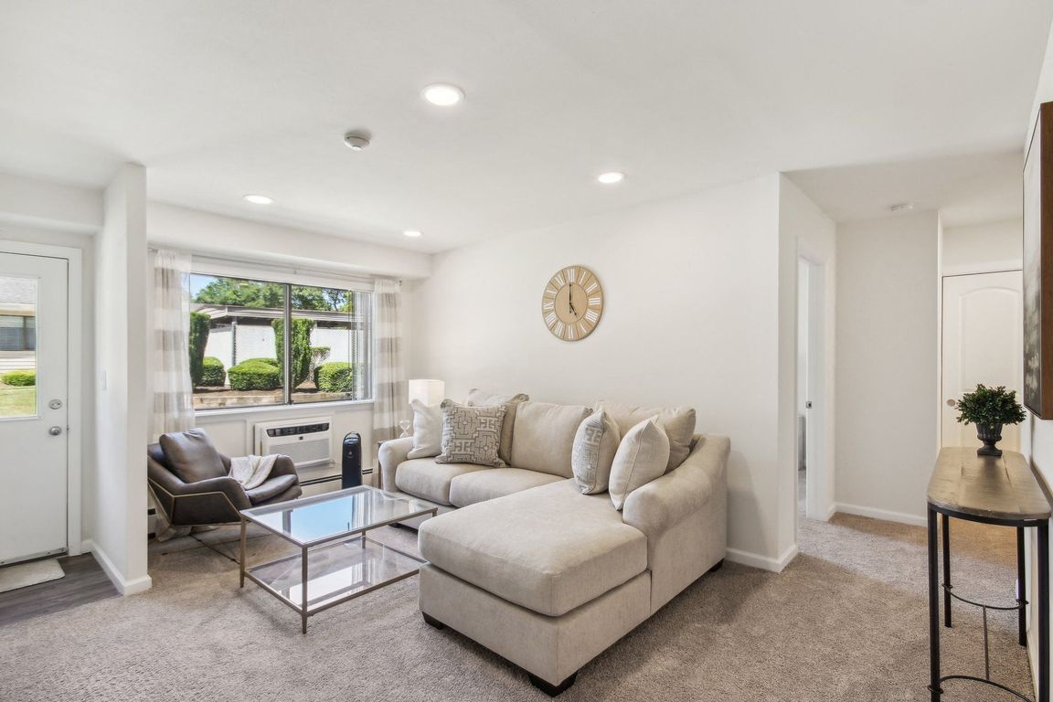 a spacious living room with a couch and a coffee table