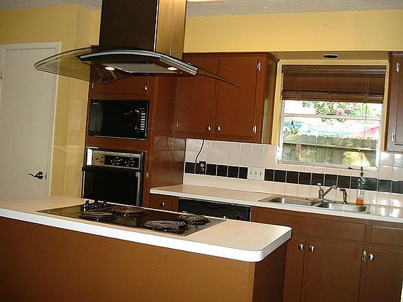 Updated vent hood and lighting! Paint and stylish hardware give the kitchen cabinets a fresh look!