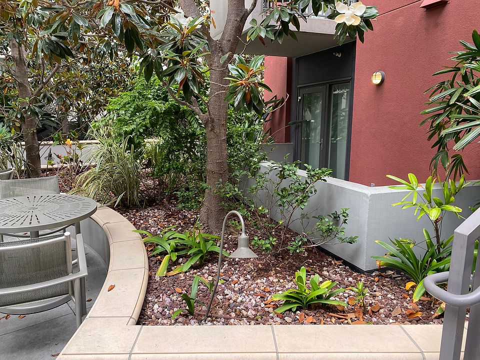 Patio door and patio of condo along side courtyard.