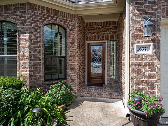 A welcoming front walkway and porch greet guests.
