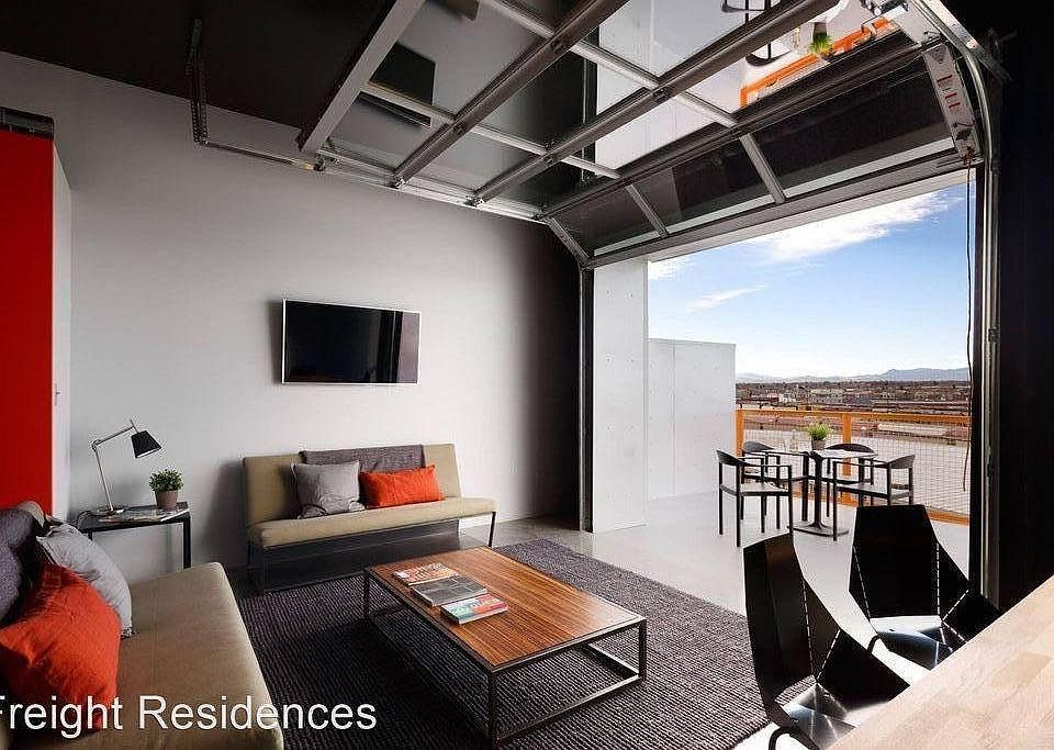 2-bedroom living room with garage door that opens up to a private balcony with mountain views.