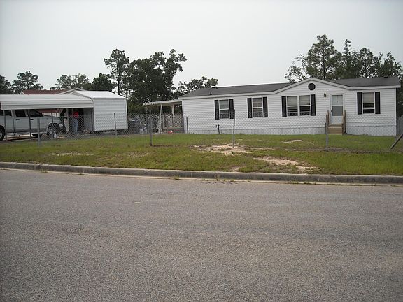 Front of House & Carport with Storage
