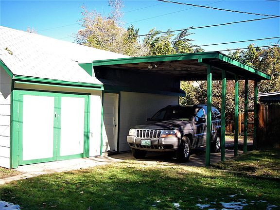 Carport off ally with garage door and Tenant storage area