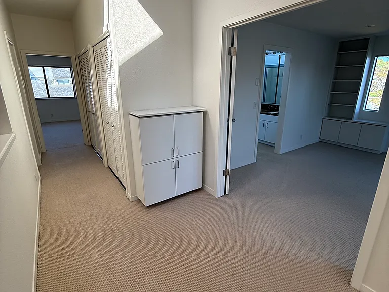 Upstairs: Spacious hallway with laundry closet and tons of storage.