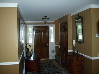 Wide foyer leading to kitchen and sunroom.