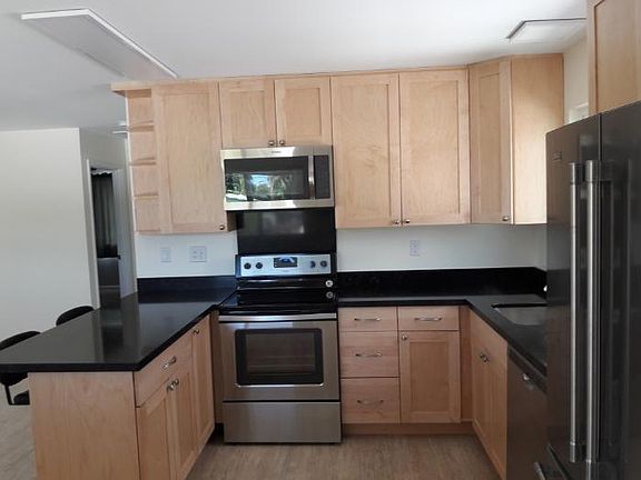 Quartz countertops, full size range, oven and microwave hood