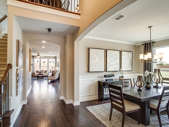 Model Representation - Inviting foyer entry showcases the formal dining room