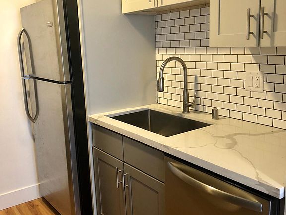 kitchen deep sink with stainless appliances.