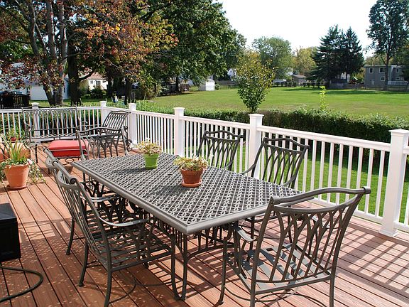 Spacious deck overlooking private yard with large town owned field.
