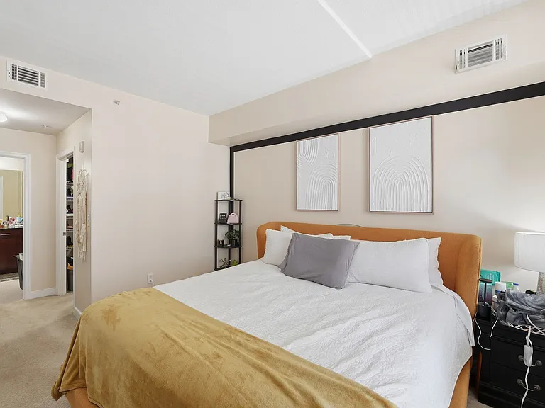 Spacious primary bedroom with large windows and abundant natural light