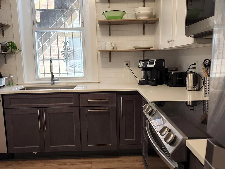 Additional view of kitchen - note large window to outside.