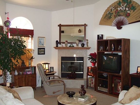 Spacious Living room with tile fireplace and vaulted ceiling